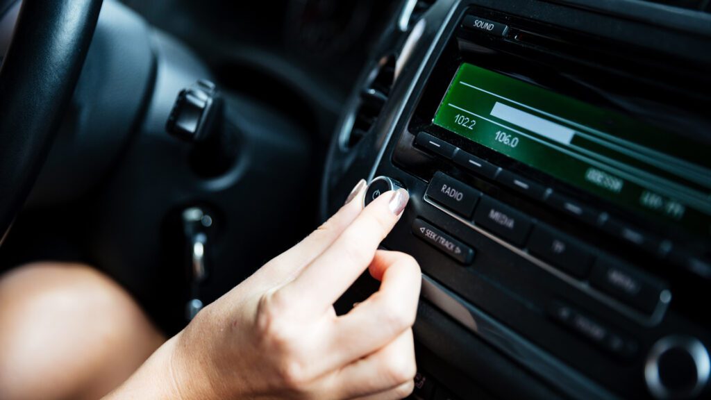 Someone listens to traditional radio in their car