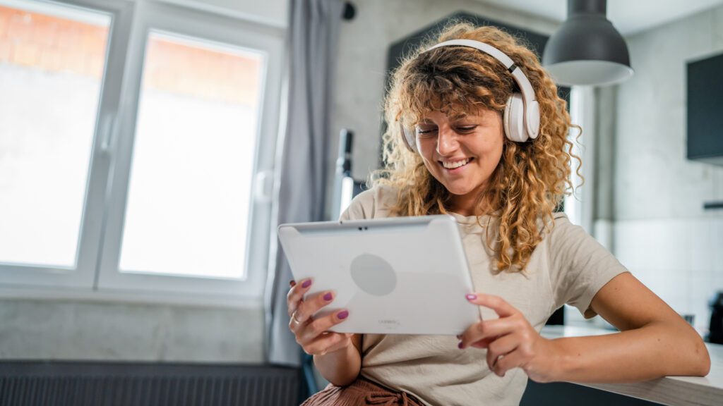 A woman watches YouTube on her tablet