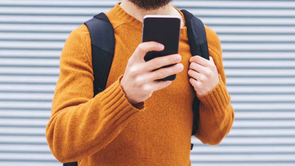 A man taps a display ad on his phone