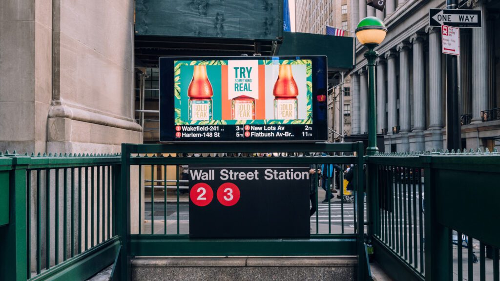 A DOOH ad near a subway entrance in New York City.